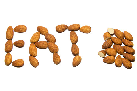 Close-up of almonds. A word made up of nuts. Screen saver. On white background. Isolated.の写真素材