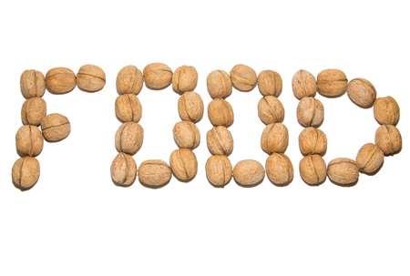 Close-up of walnut. A word made of walnuts. On white background. Isolated.の写真素材