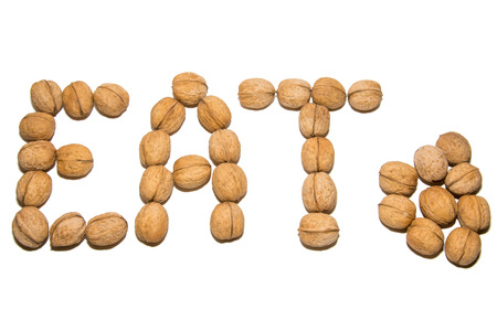 Close-up of walnut. A word made of walnuts. On white background. Isolated.の写真素材