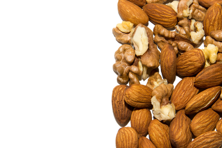 Close-up of walnut and almond. Fruits of walnuts and almonds. In the corner. From the side. On white background. Isolated.の写真素材