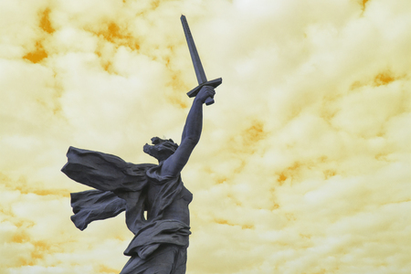 Abstraction. Mamaev Kurgan. View of the famous statue "Motherland calls." The Homeland Is Calling You! - composition center of the monument-ensemble to the Heroes of the battle of Stalingrad on Mamayev Kurgan. Yellow background.のeditorial素材