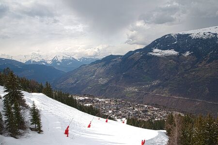 Panoramic view of ski resort three valleys and big lift in french alps - Vacation and travel concept - Winter high season opening with people having fun on mountain - Focus on sport equipmentの写真素材