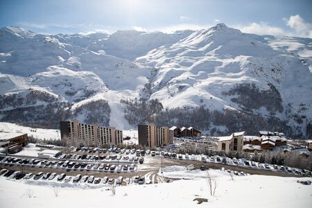 Panoramic view of ski resort three valleys and big lift in french alps - Vacation and travel concept - Winter high season opening with people having fun on mountain - Focus on sport equipmentの写真素材