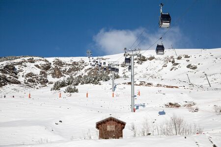 Panoramic view of ski resort three valleys and big lift in french alps - Vacation and travel concept - Winter high season opening with people having fun on mountain - Focus on sport equipmentの写真素材