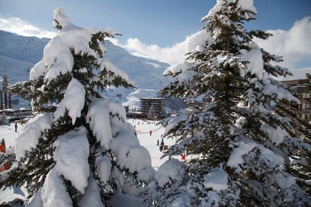 Panoramic view of ski resort three valleys and big lift in french alps - Vacation and travel concept - Winter high season opening with people having fun on mountain - Focus on sport equipmentの写真素材