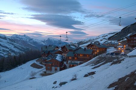 Panoramic view of ski resort three valleys and big lift in french alps - Vacation and travel concept - Winter high season opening with people having fun on mountain - Focus on sport equipmentの写真素材