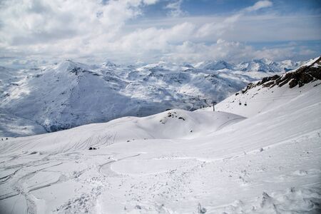 Panoramic view of ski resort three valleys and big lift in french alps - Vacation and travel concept - Winter high season opening with people having fun on mountain - Focus on sport equipmentの写真素材
