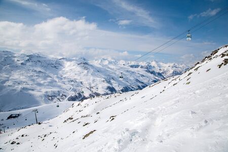 Panoramic view of ski resort three valleys and big lift in french alps - Vacation and travel concept - Winter high season opening with people having fun on mountain - Focus on sport equipmentの写真素材