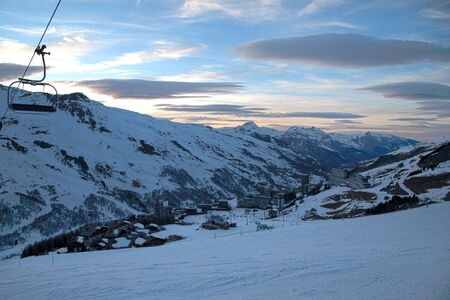Panoramic view of ski resort three valleys and big lift in french alps - Vacation and travel concept - Winter high season opening with people having fun on mountain - Focus on sport equipmentの写真素材