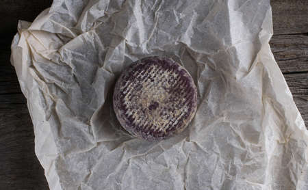 Close up of soft French cheese with purple crust on paper.flat layの写真素材