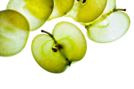 Slices of apple at the backlight isolated on a white background, macro photoの写真素材