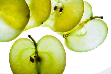 Slices of apple at the backlight isolated on a white background, macro photoの写真素材