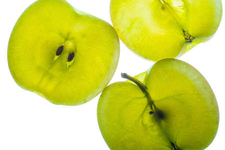 Slices of apple at the backlight isolated on a white background, macro photoの写真素材