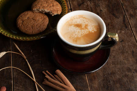 Cup of cofee and cereal cookies on the old wooden tableの写真素材