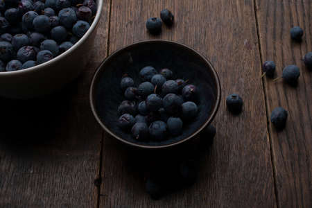 Cup and bowl of blueberries on the old wooden tableの写真素材