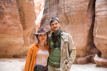 a pair of young people tourists stand in the canyon of Sik, Petraの写真素材