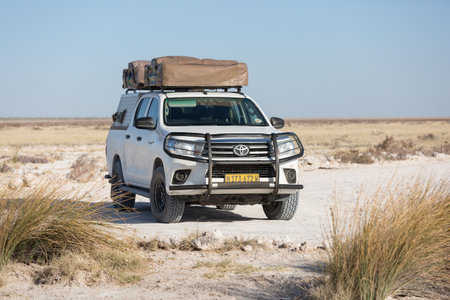 Namibia, Africa, June 18, 2019: Toyota Hilux specially equipped for travel and Gipsy Adventure house on roof rack, SUV stands in the middle of the desertのeditorial素材