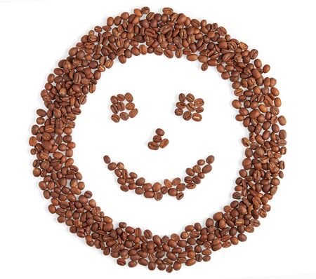 Smile face made of coffee beans smiles isolated on white backgroundの写真素材