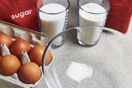 Culinary class in a kitchen. Ingredients for baking cake on a table. Cooking set. Dozen of tinted...
