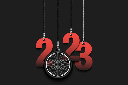 Numbers 2023 and bike wheel as a Christmas decorations are hanging on strings. New Year 2023 are...