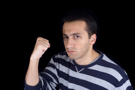 Angry young man isolated on black backgroundの写真素材