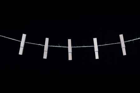 Clothespins isolated on black backgroundの写真素材