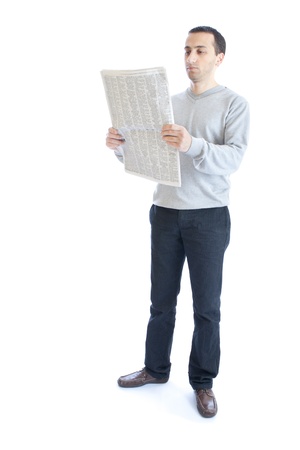 Young man reading newspaperの写真素材