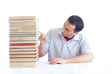 a young man with a pile of booksの写真素材