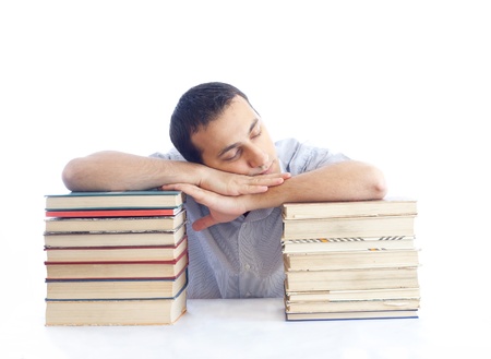a young man with a pile of books sleepingの写真素材