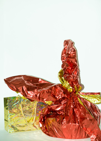 red, gold gifts close up on white backgroundの写真素材