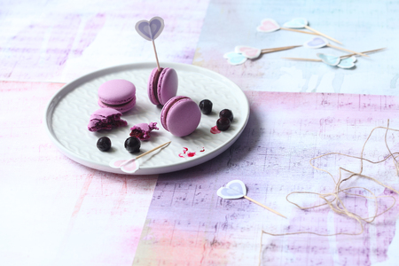 Purple Macarons with Chocolate Black Currant Filling, on gray plate, on light background.の写真素材