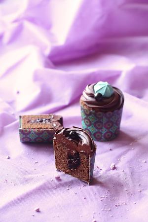 Chocolate Black Currant Cupcakes, on light purple background.の写真素材