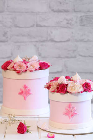 Wedding Flower Box Cake, covered with light pink fondant and decorated with pink roses, on a light...