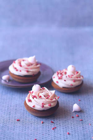 Shortbread Cookie with Blackcurrant Jam Filling and Whipped Ruby Chocolate Cream sprinkled with...