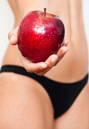 Hand offering a red appleの写真素材