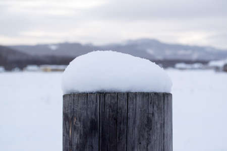 snow cap on the pillar in winterの写真素材