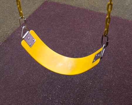 yellow childrens swing flexible chain. quality photo