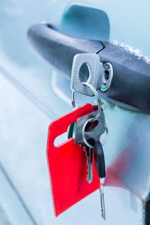 Forgotten keys inserted into car door lockの写真素材