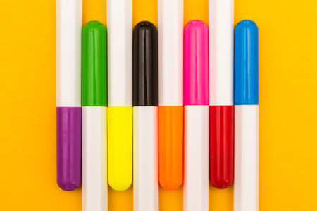 Multicolored markers on a yellow background. Photo for drawing with felt-tip pens.の写真素材