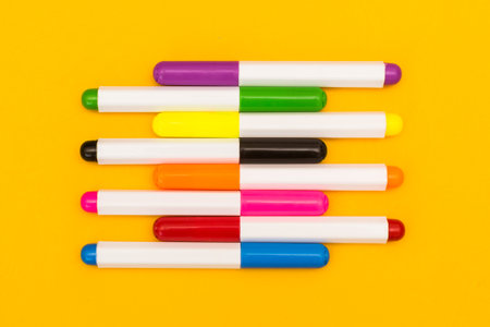 Multicolored markers on a yellow background. Photo for drawing with felt-tip pens.の写真素材
