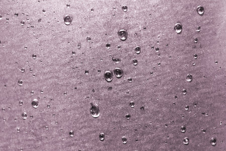 Clean water droplets on an aluminum metal surface.の写真素材