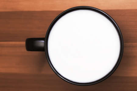 A mug with milk on the table. View from above. Copy space.の写真素材