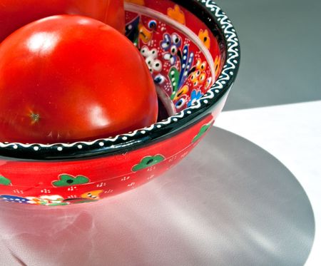tomato painted cup on the windowsill in a bright sunny dayの写真素材
