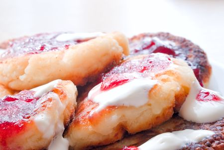 curd with raspberry jam and cream on a plateの写真素材
