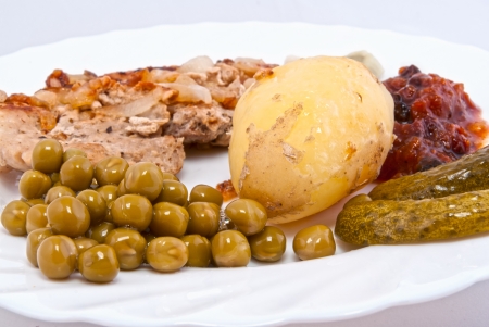 pork chop with boiled new potatoes, green peas and chutney sauceの写真素材