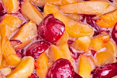 Cooking jam chopped apricots and plums in syrupの写真素材