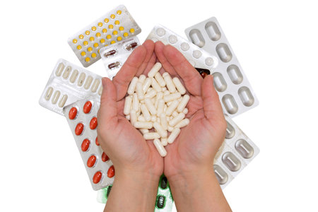 Pills in hands and bags of drugs on isolated background