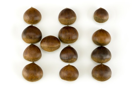 sweet chestnuts grouped in hi word on white background