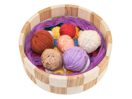 knitting and accessory in a wooden basket isolated on a white backgroundの写真素材