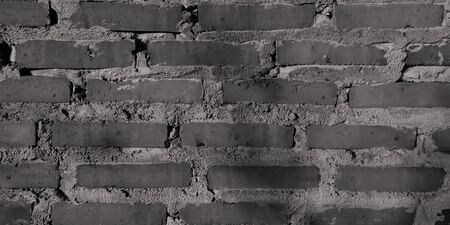 Gray brick wall background banner.â€‹